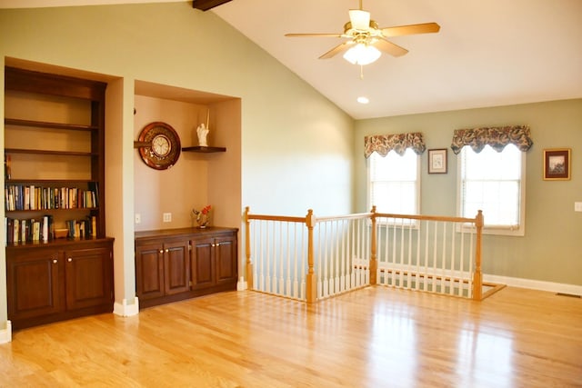 empty room with vaulted ceiling with beams, ceiling fan, and light wood-type flooring