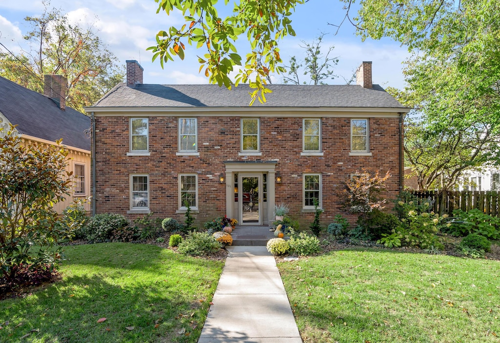 colonial inspired home with a front yard