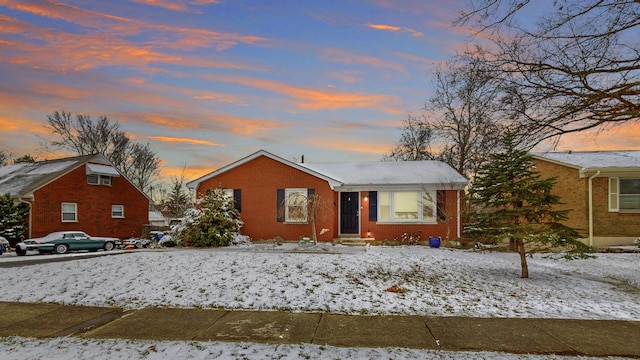 bungalow-style house with brick siding