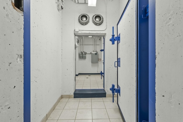 hall featuring light tile patterned floors