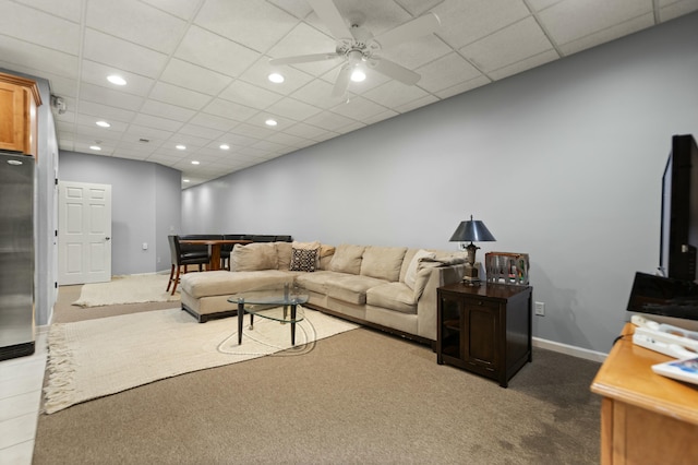 carpeted living room with a drop ceiling and ceiling fan