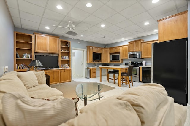 living room featuring ceiling fan, a paneled ceiling, and light carpet