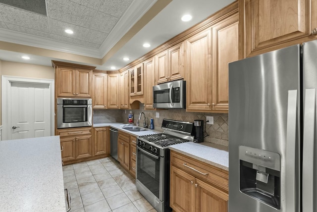 kitchen with light tile patterned flooring, sink, backsplash, stainless steel appliances, and crown molding