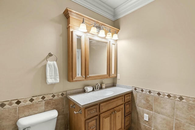 bathroom with crown molding, vanity, toilet, and tile walls