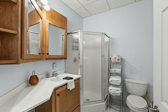 bathroom with vanity, toilet, and a shower with door