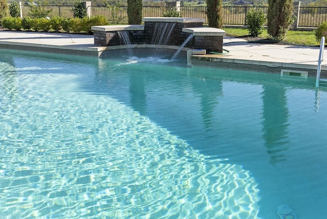 view of swimming pool featuring pool water feature