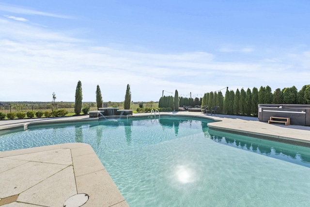 view of pool with a patio, a hot tub, and pool water feature