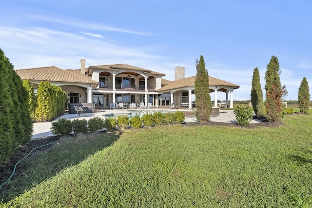 back of property featuring a balcony, a pool, a yard, a gazebo, and a patio area