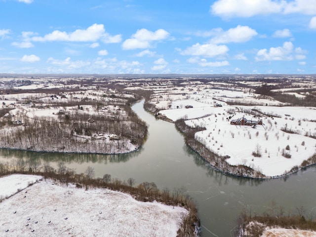 snowy aerial view with a water view