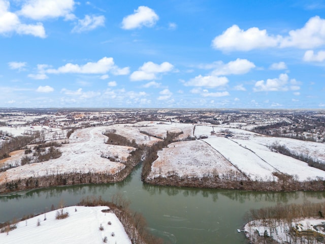 snowy aerial view featuring a water view