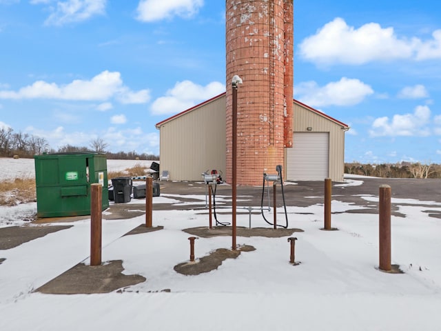 view of snow covered exterior featuring a garage