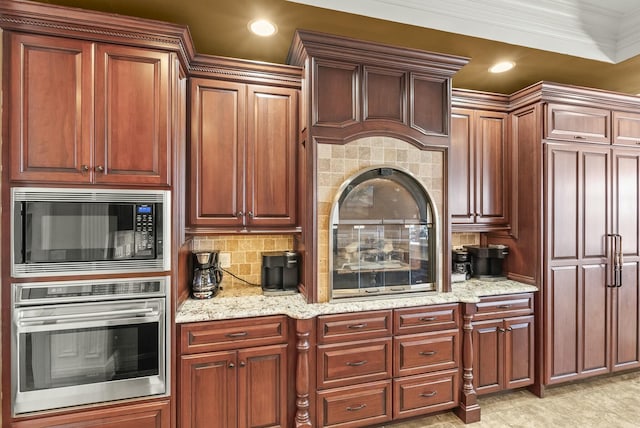 kitchen with black microwave, backsplash, oven, ornamental molding, and light stone counters