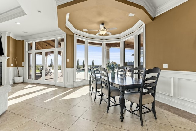 tiled dining space with crown molding, french doors, and ceiling fan