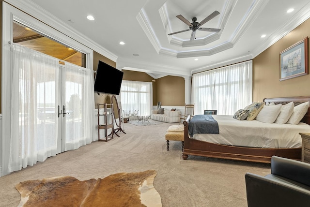 bedroom with french doors, crown molding, light carpet, a tray ceiling, and ceiling fan