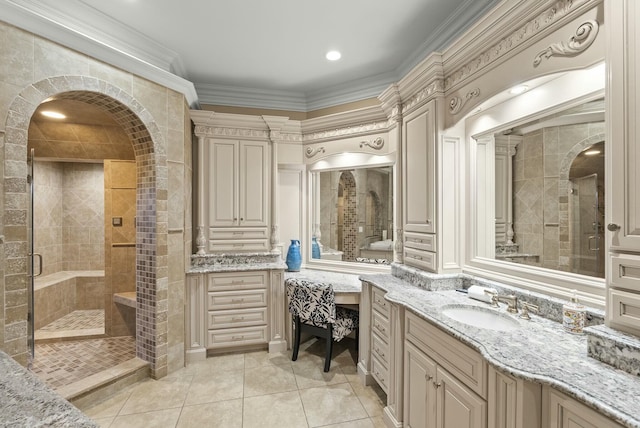 bathroom featuring vanity, tile patterned flooring, crown molding, and walk in shower