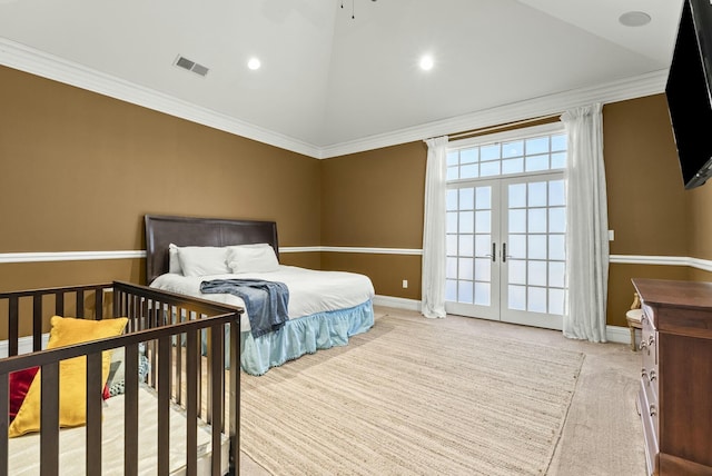 carpeted bedroom with lofted ceiling, ornamental molding, and french doors