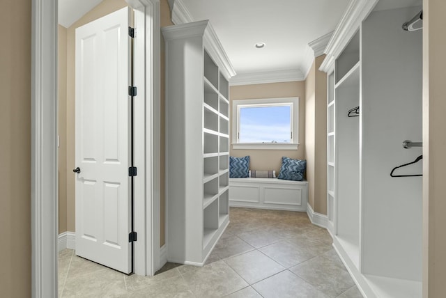 hallway with crown molding and light tile patterned floors