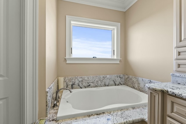 bathroom featuring vanity, a bathtub, and ornamental molding