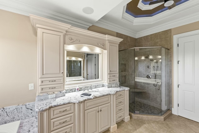 bathroom with vanity, crown molding, a shower with shower door, and tile patterned floors