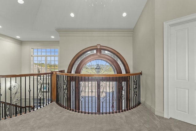 interior space featuring ornamental molding, a chandelier, and carpet