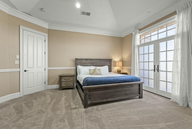 carpeted bedroom with crown molding, vaulted ceiling, and french doors