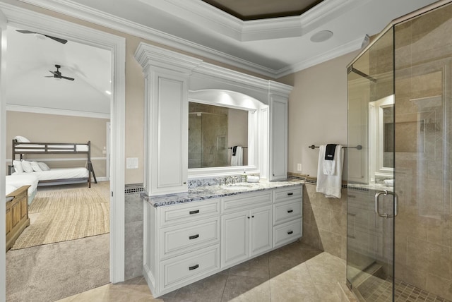 bathroom featuring a shower with door, ceiling fan, tile walls, vanity, and ornamental molding