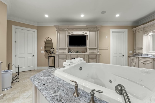 bathroom with a washtub, vanity, crown molding, and tile patterned floors