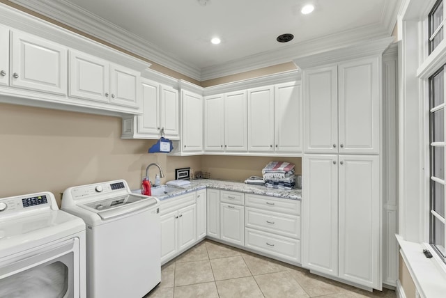 laundry area featuring sink, light tile patterned floors, cabinets, ornamental molding, and washer and dryer