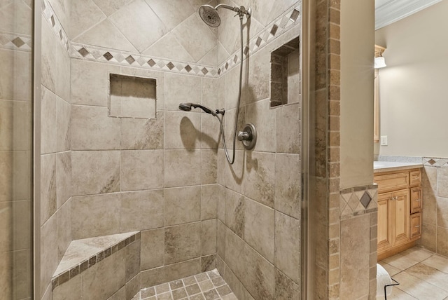 bathroom featuring crown molding, vanity, tile walls, and a tile shower