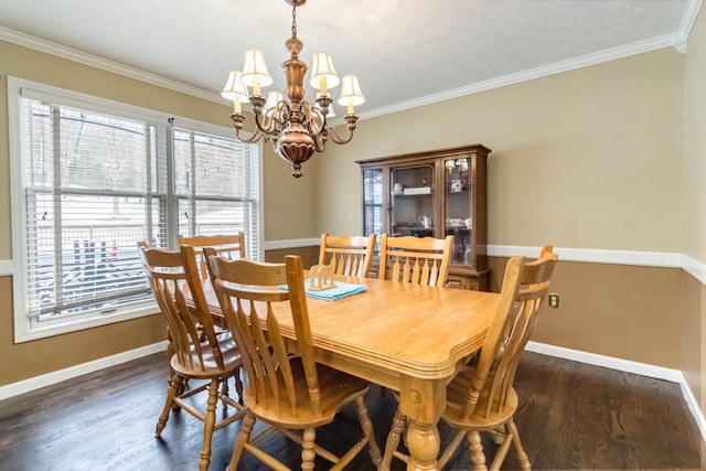 dining space featuring ornamental molding, dark wood-type flooring, and a notable chandelier