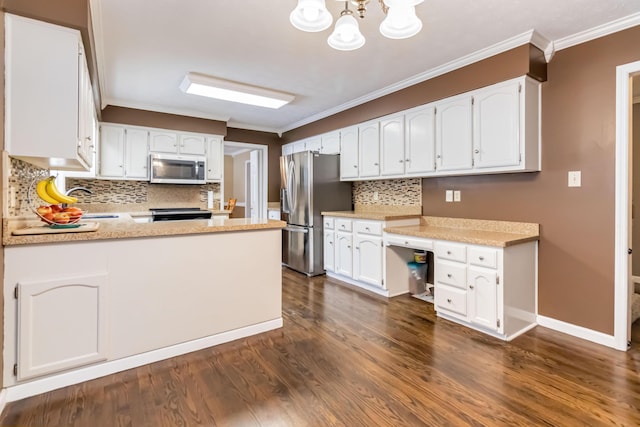 kitchen with dark wood-type flooring, white cabinetry, built in desk, ornamental molding, and appliances with stainless steel finishes