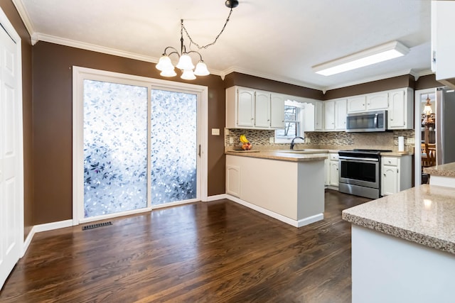 kitchen featuring dark hardwood / wood-style flooring, decorative light fixtures, stainless steel appliances, and white cabinets