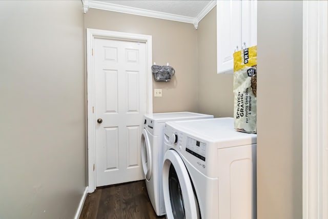 laundry room with cabinets, crown molding, dark hardwood / wood-style floors, and washer and clothes dryer