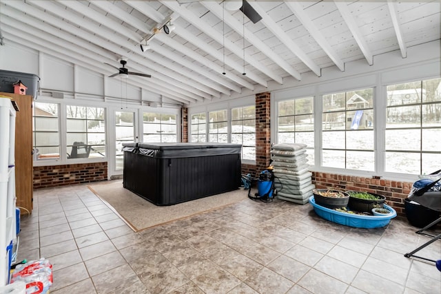 sunroom with wood ceiling, ceiling fan, plenty of natural light, and vaulted ceiling with beams