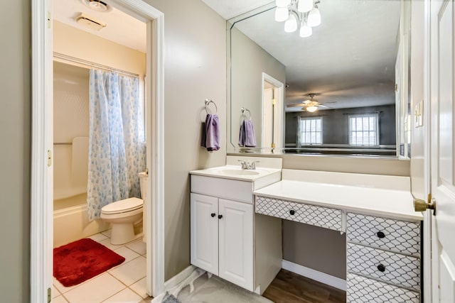 full bathroom with shower / tub combo with curtain, ceiling fan, vanity, tile patterned floors, and toilet