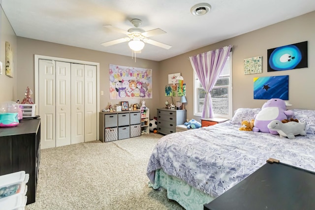 carpeted bedroom with ceiling fan and a closet