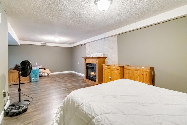 bedroom with dark hardwood / wood-style flooring and a textured ceiling