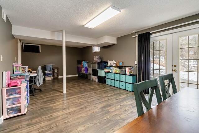 bedroom with hardwood / wood-style flooring and a textured ceiling