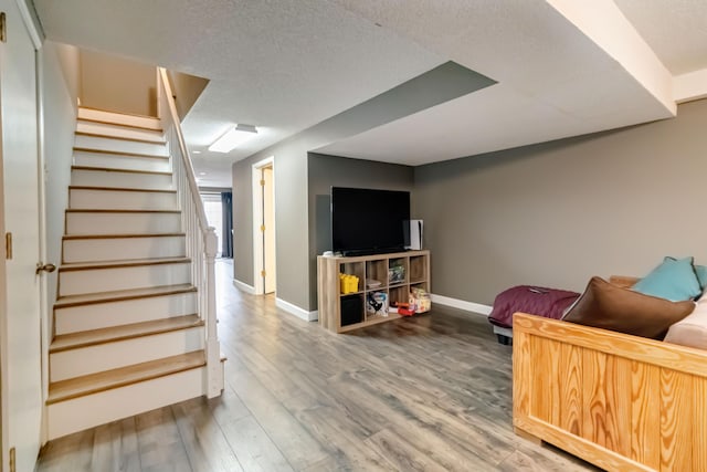 living room with hardwood / wood-style flooring and a textured ceiling