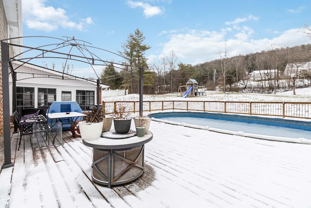 snow covered pool featuring a playground