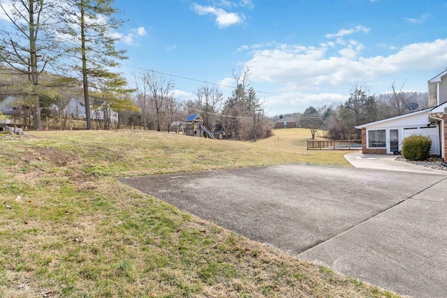 view of yard featuring a playground and a patio area