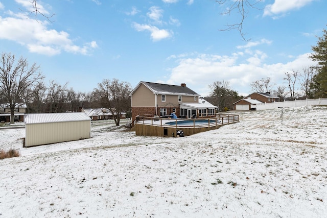 snow covered property featuring an outdoor structure