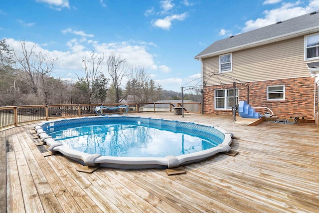 view of pool featuring a wooden deck and a gazebo