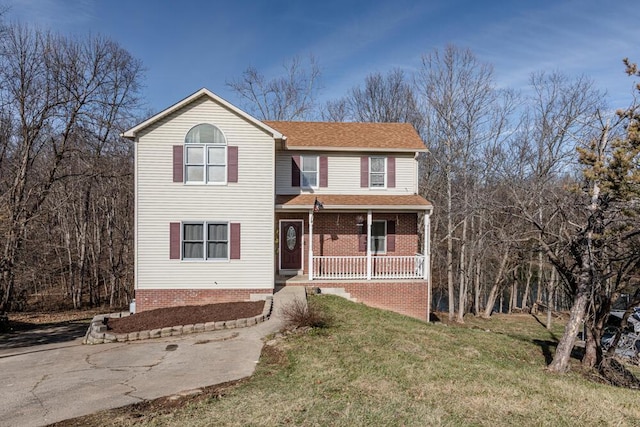 front facade with a front lawn and covered porch