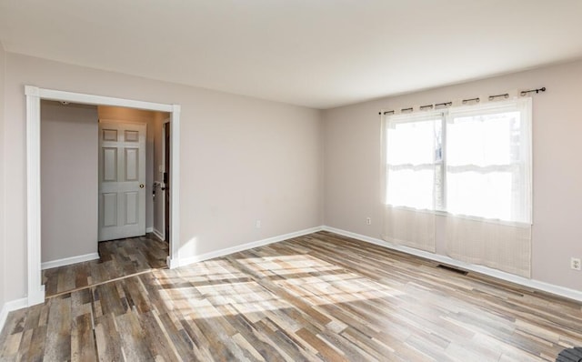 empty room with hardwood / wood-style floors