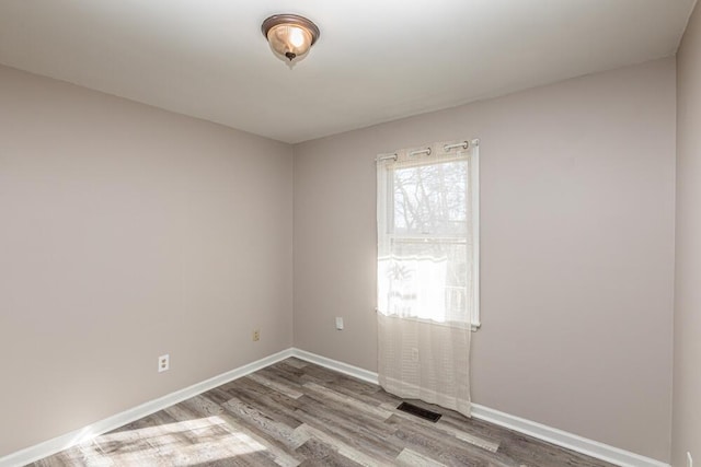 empty room with wood-type flooring