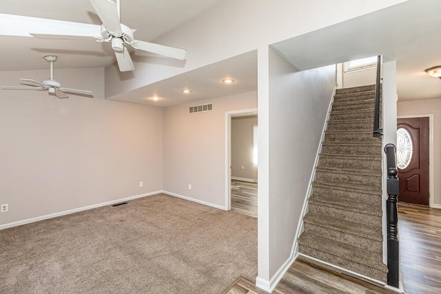 interior space with carpet, ceiling fan, and lofted ceiling