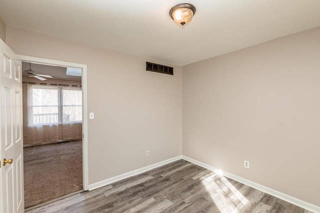 spare room featuring hardwood / wood-style floors and ceiling fan