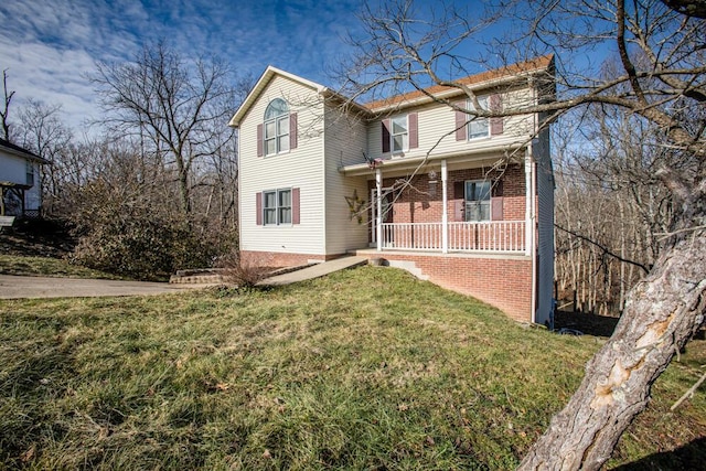 front facade with a porch and a front lawn