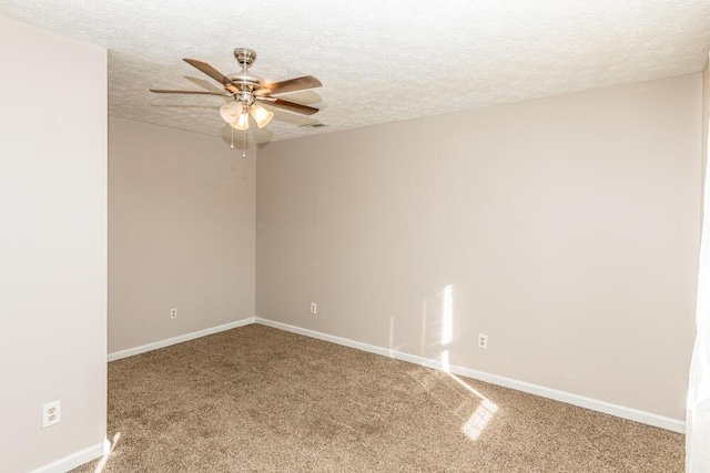 carpeted empty room featuring ceiling fan and a textured ceiling